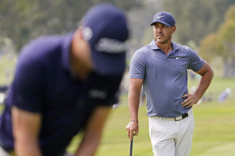The Latest: Henley, Bland lead, Mickelson advances