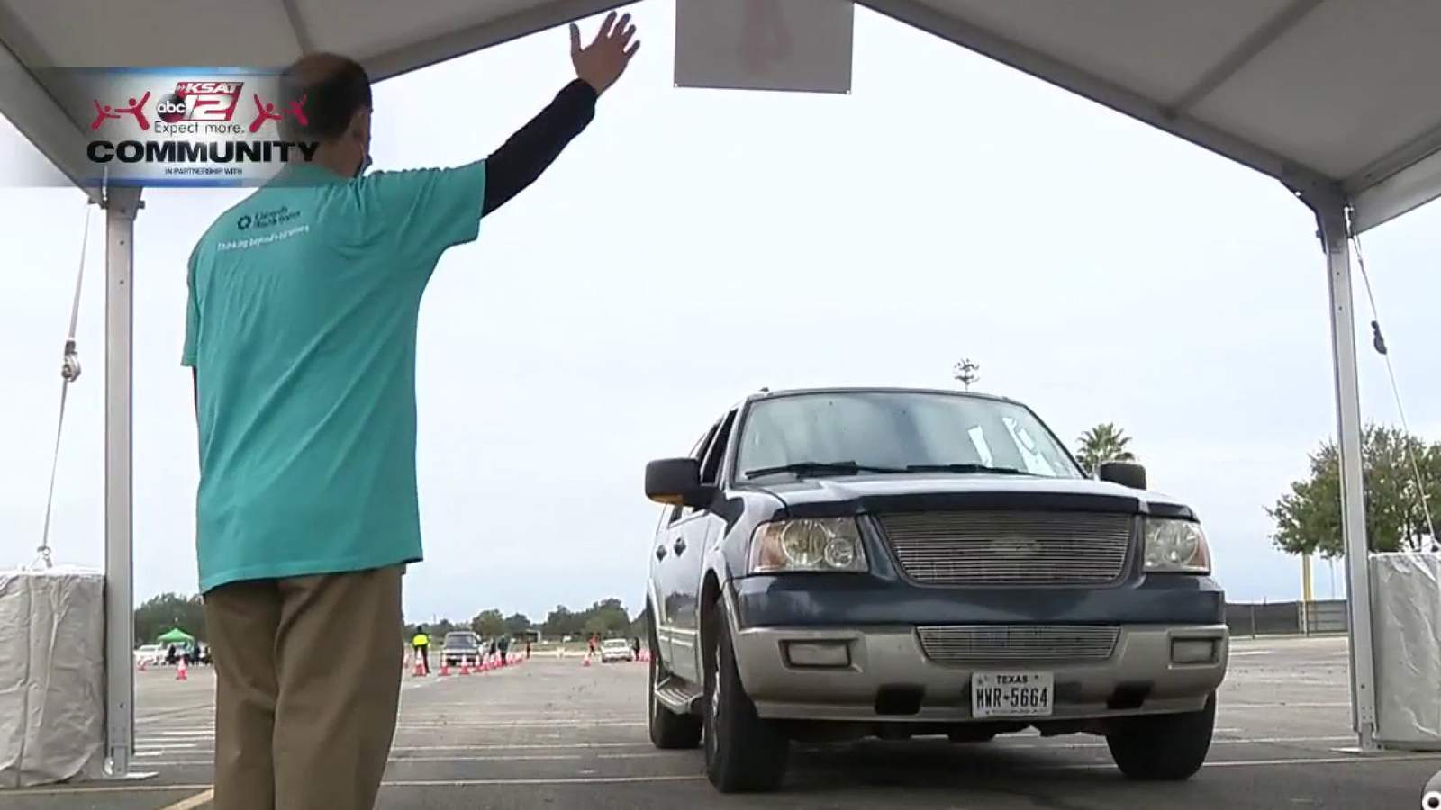 San Antonians line up to receive their flu shots from the comfort of their cars