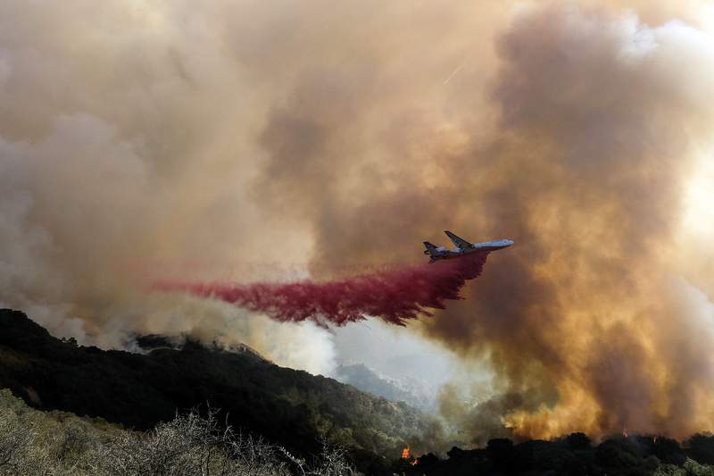 California highway reopens but fire still a threat to homes