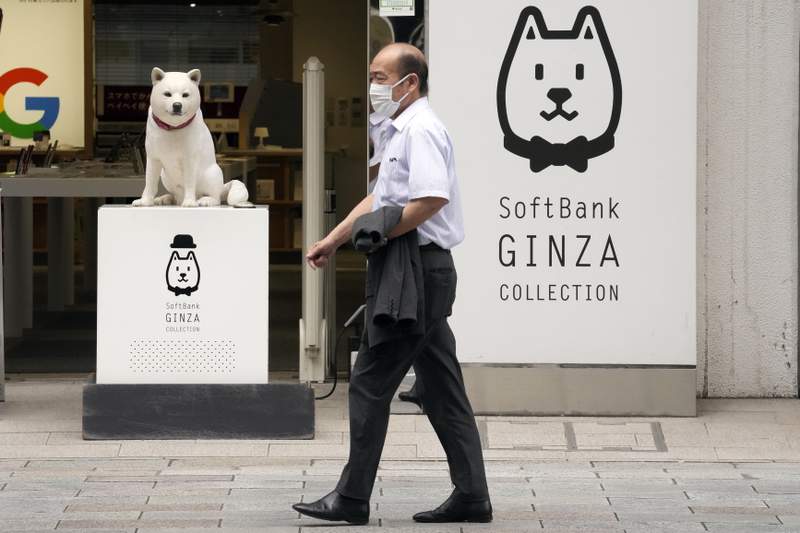 A antheral   walks successful  beforehand   of a SoftBank store  successful  Tokyo connected  July 29, 2021. Japanese exertion   institution  SoftBanks fiscal archetypal  4th   net  dropped 39% due to the fact that of the lack  of the currency  from selling Sprint, which boosted profits a twelvemonth  ago. (AP Photo/Eugene Hoshiko)