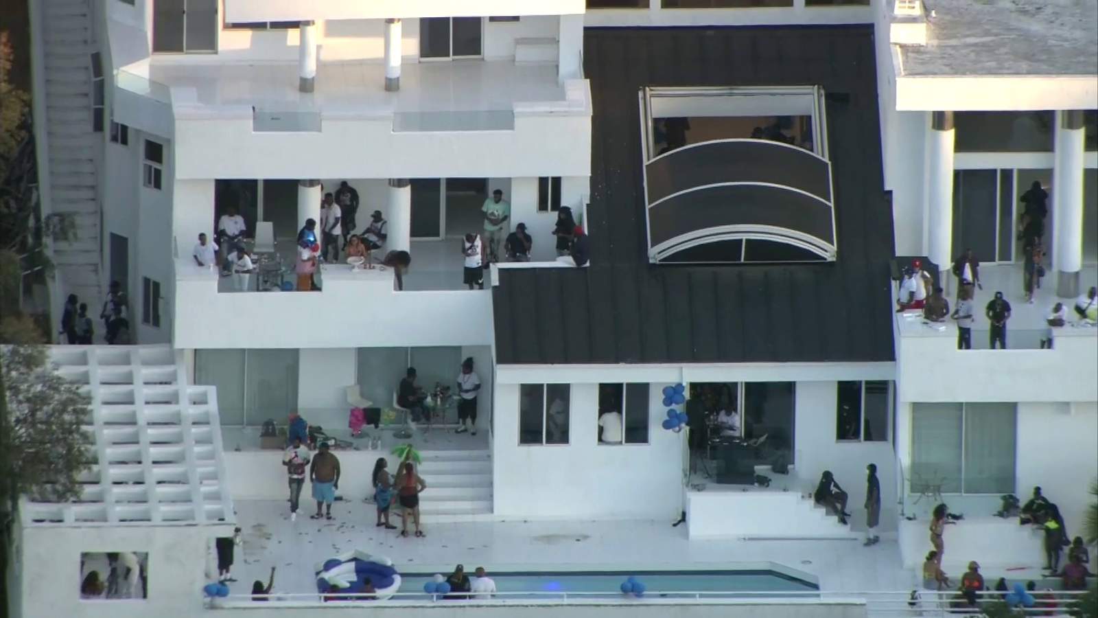Aerial footage shows large crowd at Los Angeles mansion hours before fatal shooting