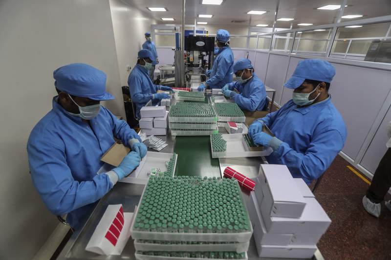 FILE- In this Jan. 21, 2021, record  photo, employees battalion  boxes containing vials of Covishield, a mentation    of the AstraZeneca vaccine astatine  the Serum Institute of India successful  Pune, India. India, the world's largest vaccine producer, says it volition  resume exports and donations of surplus coronavirus vaccines successful  October aft  halting them during a devastating surge successful  home  infections successful  April. (AP Photo/Rafiq Maqbool, File)