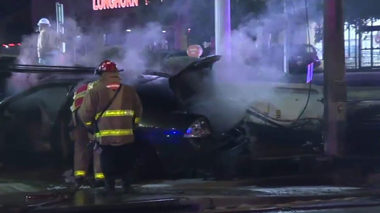 Woman’s car catches fire after crashing into utility pole, police say