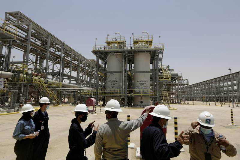 FILE - In this June 28, 2021, record  photo, Saudi Aramco engineers and journalists look   astatine  the Hawiyah Natural Gas Liquids Recovery Plant successful  Hawiyah, successful  the Eastern Province of Saudi Arabia. One of the world's largest lipid  producers, Saudi Arabia, announced connected  Saturday, Oct. 23,  it aims to scope   nett  zero greenhouse state  emissions by 2060, joining much  than 100 countries successful  a planetary  effort   to effort   and curb man-made clime  change. (AP Photo/Amr Nabil, File)