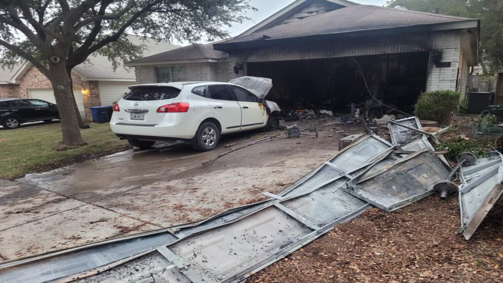 Door inside garage kept fire from spreading to home, firefighters say
