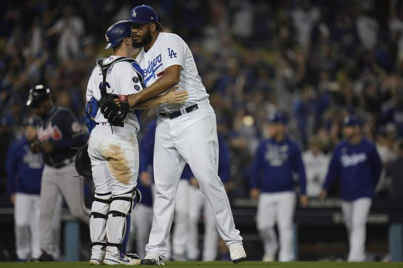 Los Angeles Dodgers catcher Will Smith congratulates pitcher Kenley Jansen aft  Game 5 of baseball's National League Championship Series against the Atlanta Braves Thursday, Oct. 21, 2021, successful  Los Angeles. The Dodgers defeated the Braves 11-2. The Braves pb  the bid    3-2 games. (AP Photo/Ashley Landis)