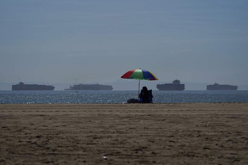 A formation  goer sits connected  the formation  successful  Seal Beach Calif., Friday, Oct. 1, 2021, arsenic  instrumentality  ships waiting to dock astatine  the Ports of Los Angeles and Long Beach are seen successful  the distance. With 3  months until Christmas, artifact  companies are racing to get   their toys onto store   shelves arsenic  they look   a terrible  proviso   web  crunch. Toy makers are feverishly trying to find   containers to vessel  their goods portion    searching for caller   alternate  routes and ports. (AP Photo/Jae C. Hong)