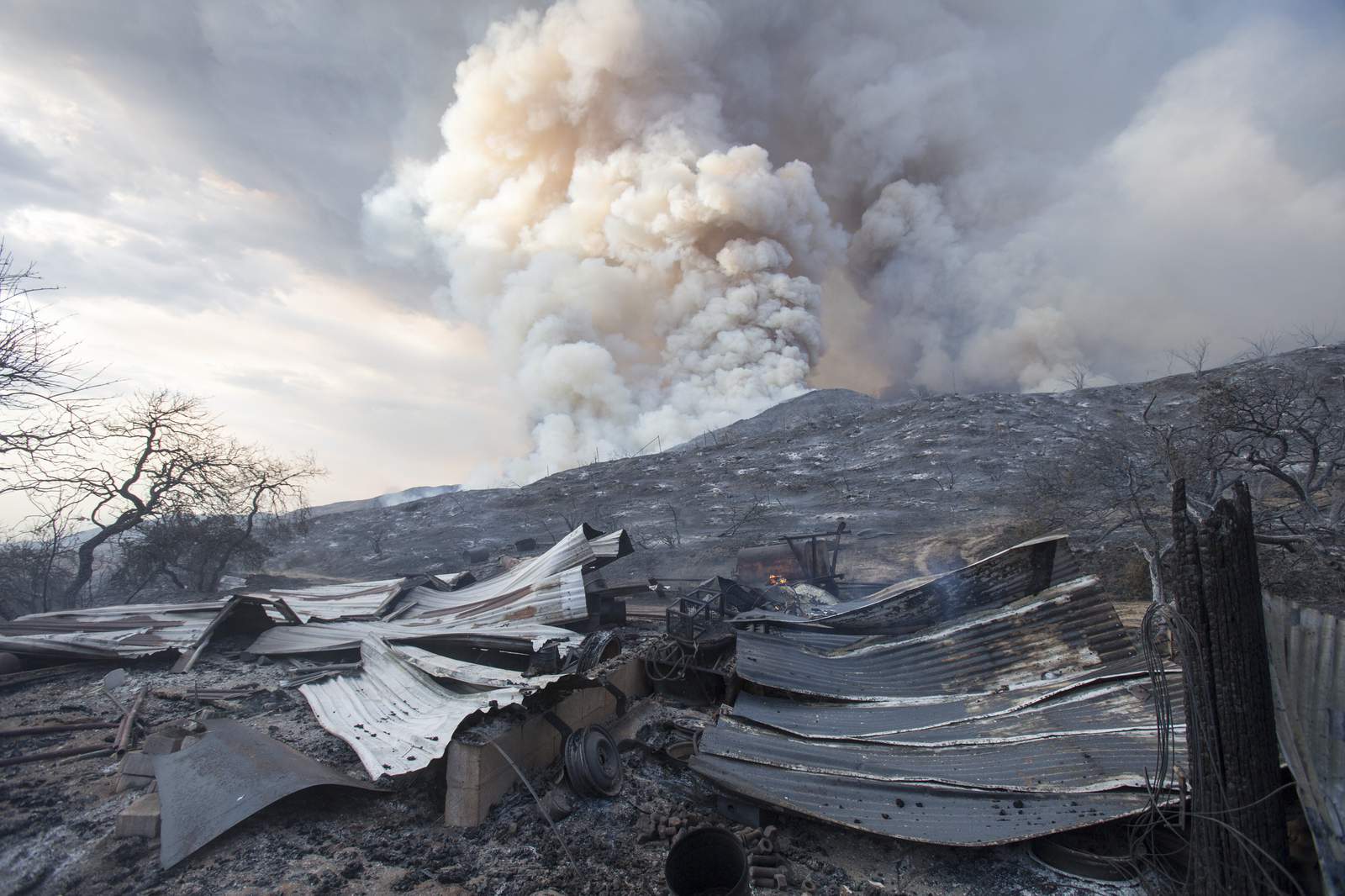 Homes burned as winds push California fire into desert floor