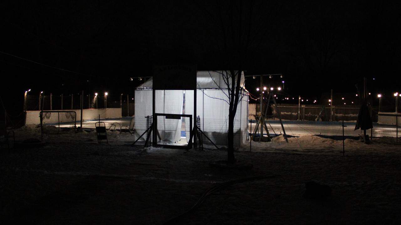 This massive backyard ice rink has it all -- even a scoreboard, flood lights and a warming tent