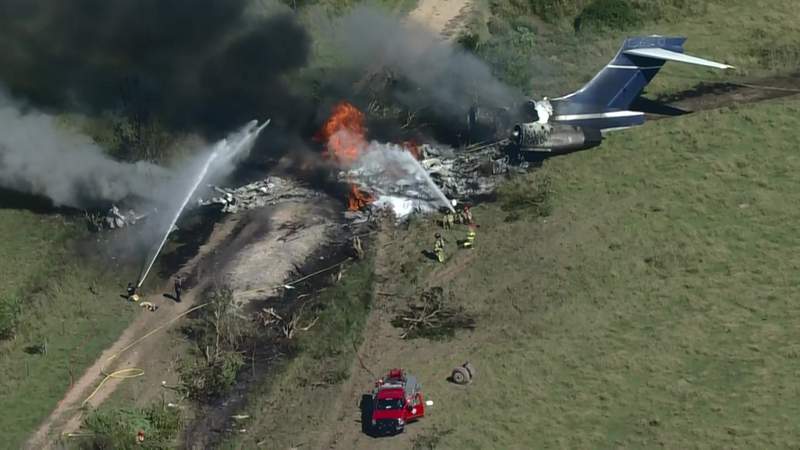 Aerial photos show fiery plane crash near Houston where all 21 passengers survived