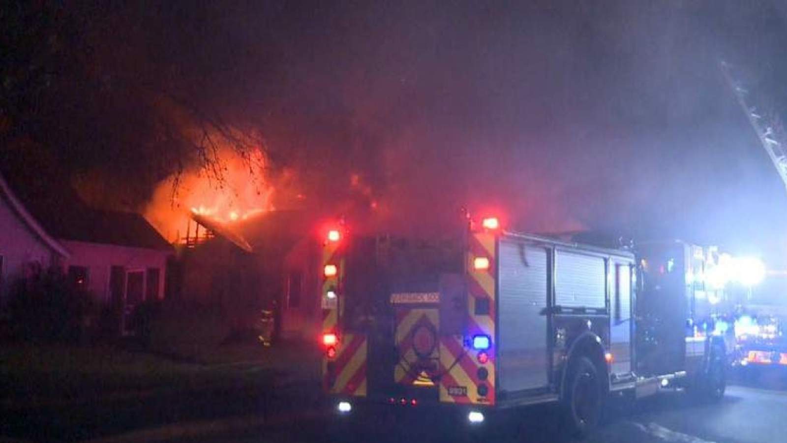 Firefighters scramble to protect neighboring homes from fast-spreading flames
