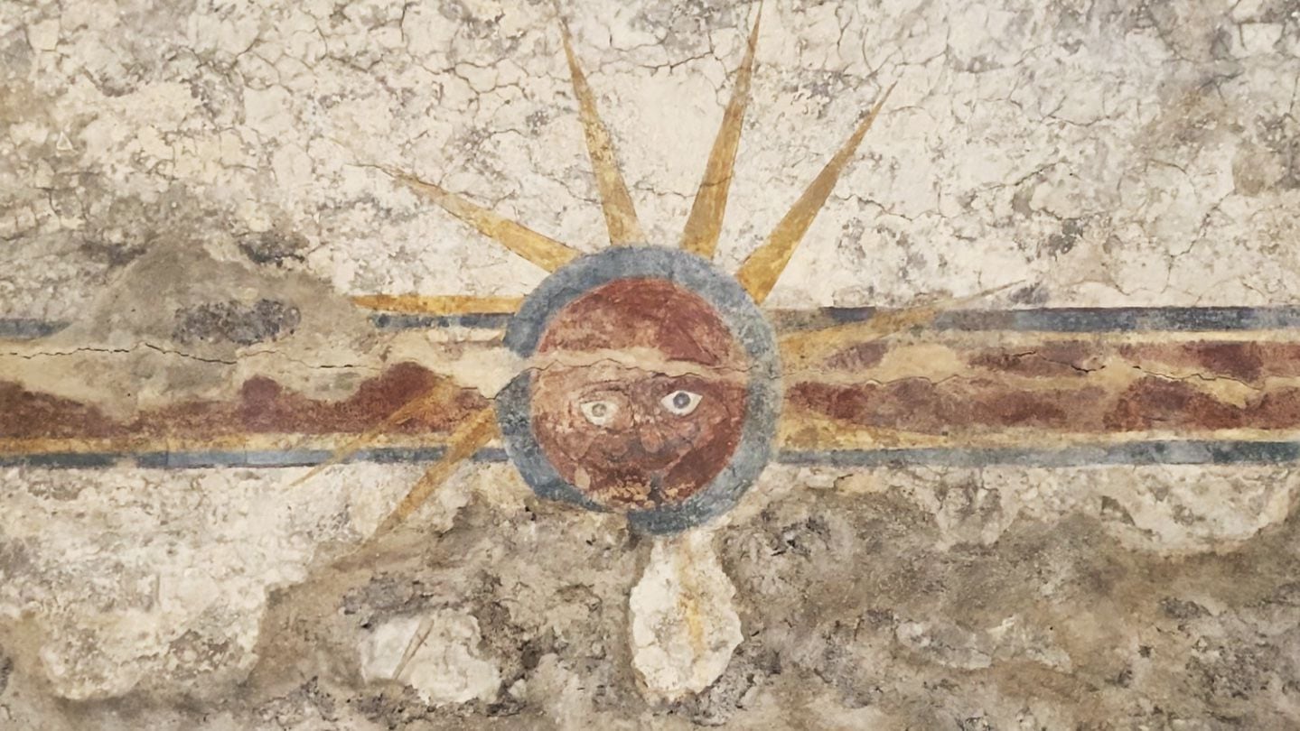 Fresco at Mission Concepción, showing the sun, moon, and face of Jesus.