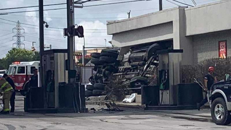 Semi-truck carrying asphalt rolls over into store on Northeast Side; 3 taken to hospital