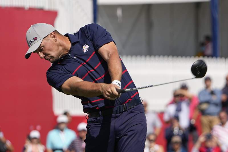 The Latest: Europe salvages tie, still trails at Ryder Cup