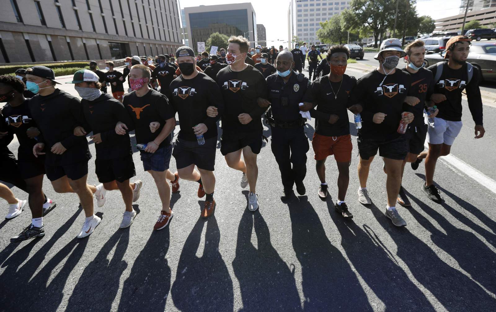Texas football players march to Capitol to honor Floyd