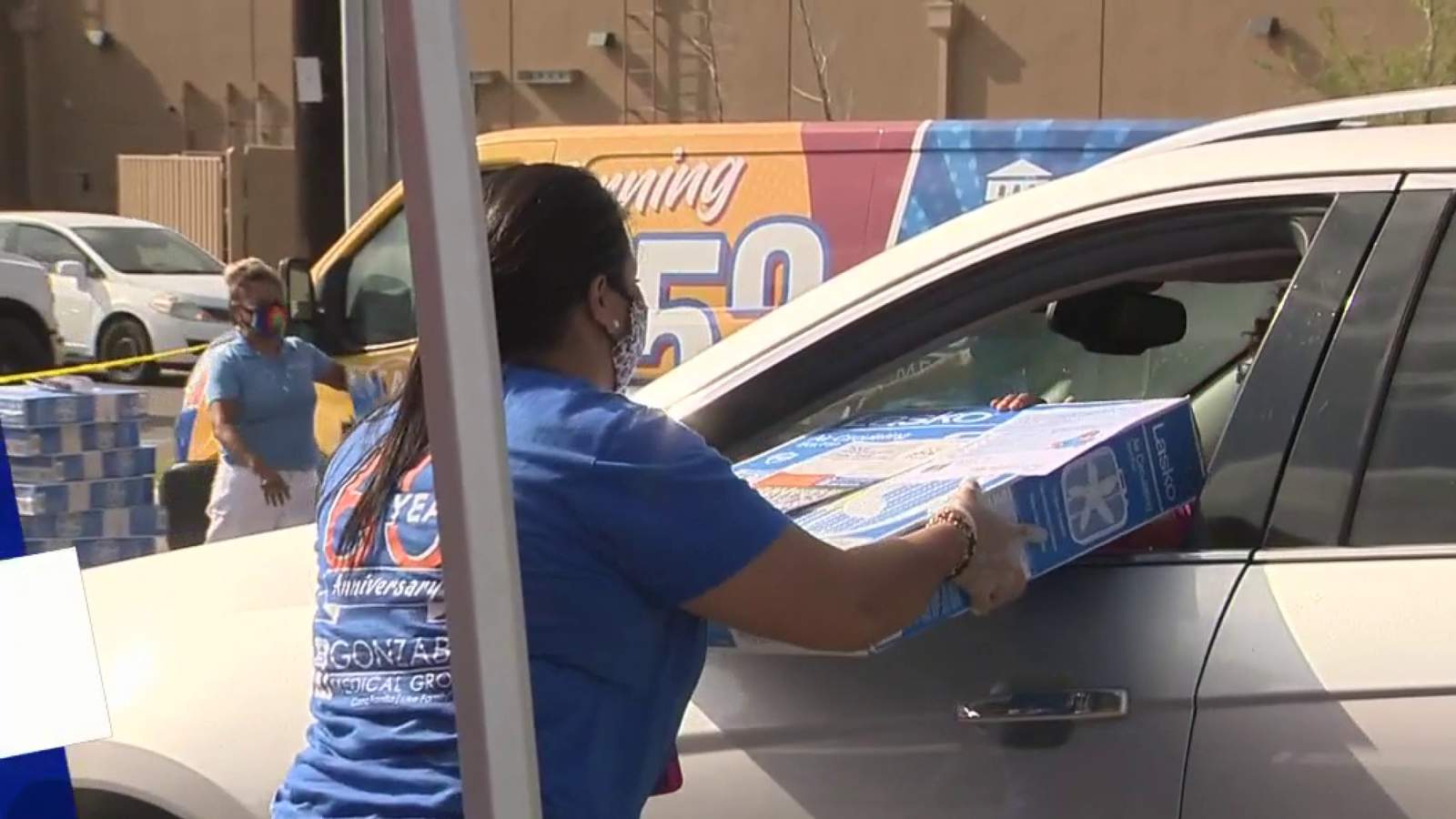 Senior citizens receive free fans at drive-thru giveaway
