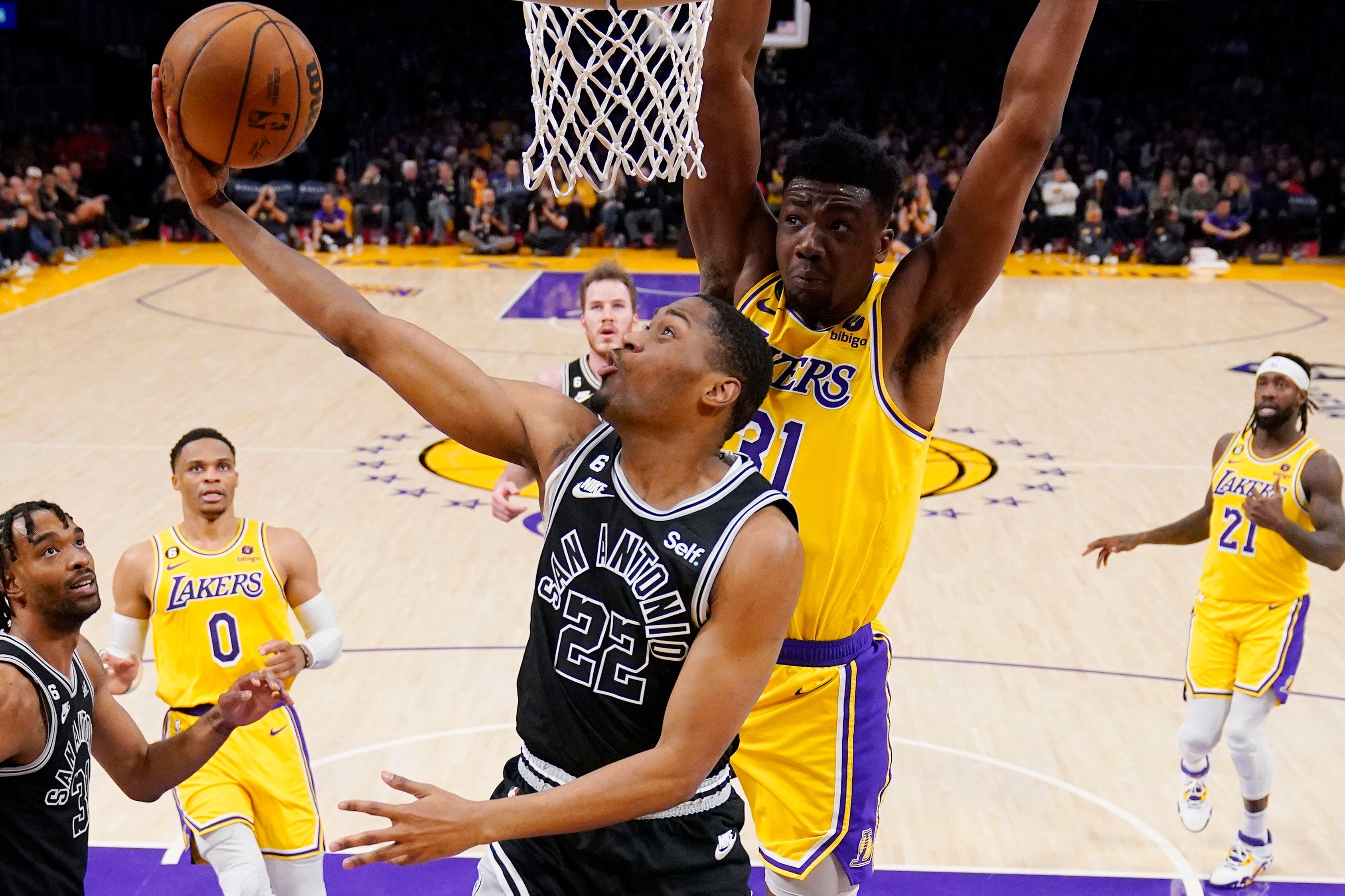 San Antonio Spurs guard Malaki Branham (22) shoots as Los Angeles Lakers center Thomas Bryant defends during the first half of an NBA basketball game Wednesday, Jan. 25, 2023, in Los Angeles. (AP Photo/Mark J. Terrill)