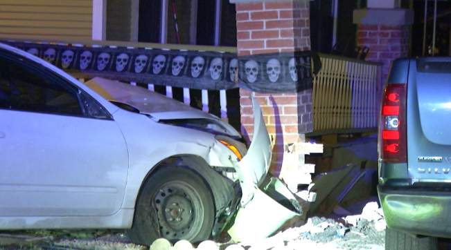 Woman crashes vehicle into parked car, pillar and patio of East Side home, police say